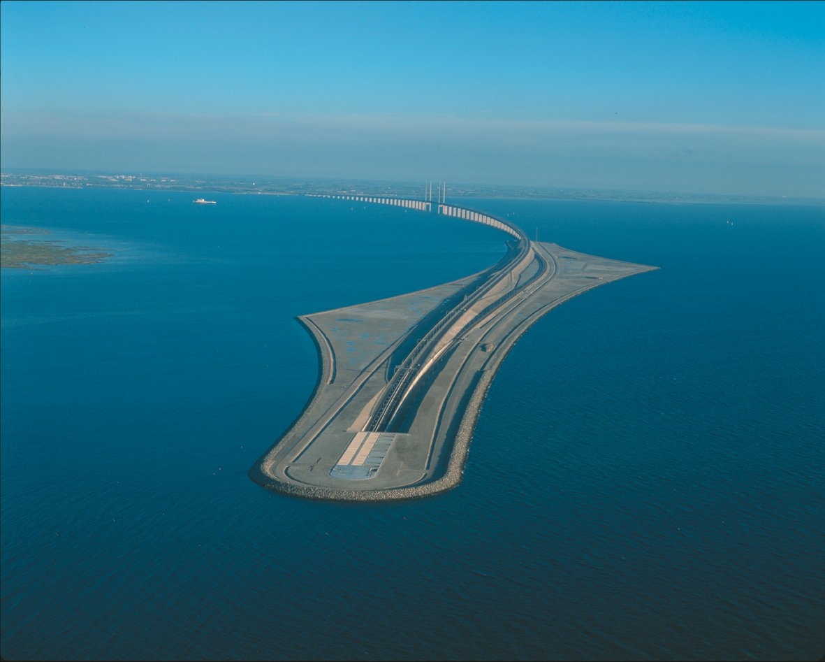 Oresund link, the tunnel entrance on Peberholm artificial island and the bridge in the background - in spring 1993, the Øresund Consortium held a competition between six prequalified consultancy groups and chose two projects to be used in tendering for contractors. One of them was the one from Øresund Link Consultants (Rambøll, Hannemann & Højlund, Scandiaconsult, Sir William Halcrow & Partners and Tunnel Engineering Consultants). It was the other design that won the completion and was realised. For the detailed design phase, Rambøll was unfortunately also not part of the winning team. 

However, in the following years, there were major assignments  for Ramboll and its partners, especially for the design of the tunnel. Ramboll was also given the role of the client's consultant for the whole Link. And after it went into operation, Ramboll won inspection contracts for the maintenance of the bridge structure. 